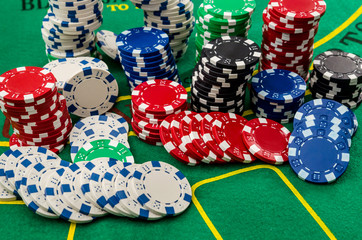 Poker cards and chips on green table