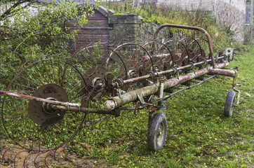 Trailer for a tractor. The trailer is designed for harvesting mowed grass and hay from the field. Mechanical rake. Podlasie , Poland.