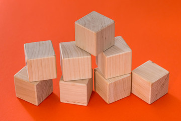 empty wooden cubes blocks  isolated on orange background