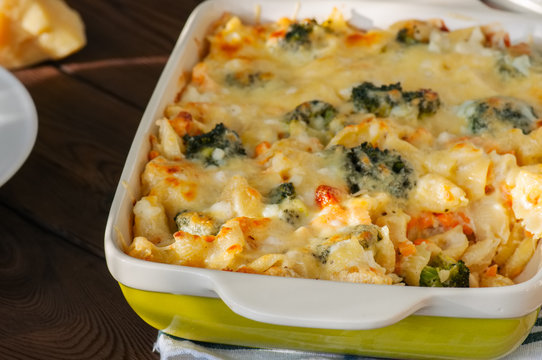 Broccoli And Pumpkin Mac And Cheese In A Ceramic Dish On A Wooden Background. Close Up.