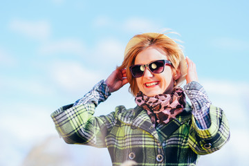 Happy young blond fashion woman in forest