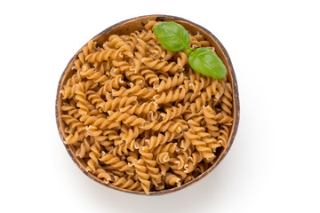 Uncooked wholemeal pasta isolated white background.
