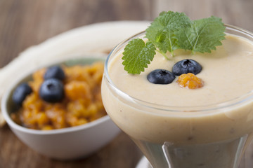  Smoothies with cloudberries, a banana and a blueberry