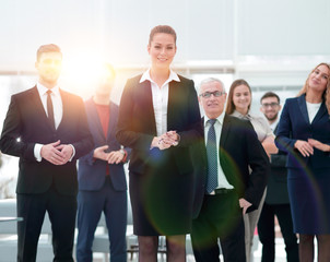 confident business woman standing in front of his business team.