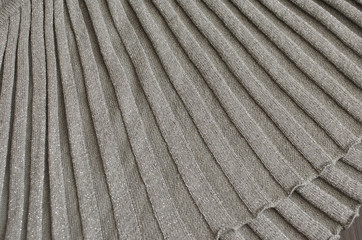 Background grey texture of beige pattern knitted fabric made of cotton or wool closeup