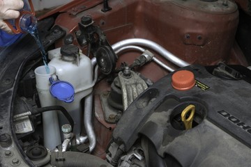 the car mechanic fixes the car engine by tools