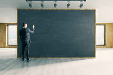 Man writing on chalkboard