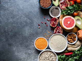 Fresh raw ingredients for healthy cooking. Vegetables, fruit, seeds, cereals, beans, spices, superfoods, herbs. Top view. Diet or vegetarian food concept. Copy space