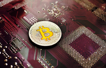 silver coin bitcoin on a microchip background. Crypto currency, electronic