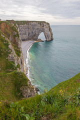 Fototapeta na wymiar Famous chalk cliffs and natural arches located on the coast of the Pays de Caux area at Etretat, Normandy, France