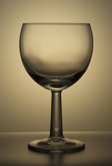 Empty drinking glass on a glass board.
