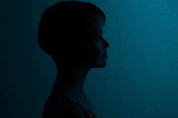 Silhouette of a girl with short hair studio portrait