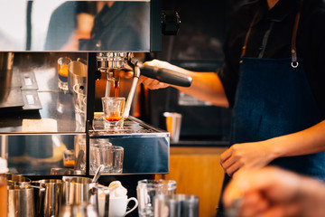 Women Barista to make a Espresso shot in coffee shop, vintage tone.