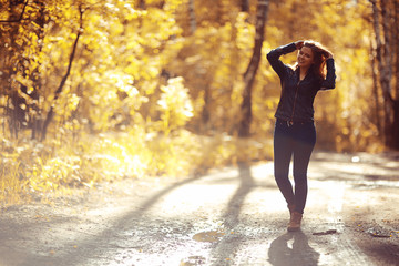 Young adult girl on a walk in the park jacket clothes