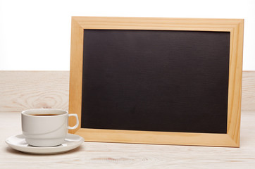 Blank board and cup of coffee.