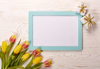 Blank sheet, gift and tulips.