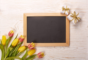 Blank sheet, gift and tulips. .