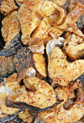 Pieces of grilled smoked fish trout with spices and pepper