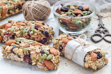 Homemade granola energy bars with figs, oatmeal, almond, dry cranberry and pumpkin seeds, healthy...