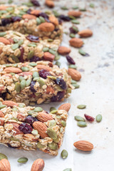 Homemade granola energy bars with figs, oatmeal, almond, dry cranberry and pumpkin seeds, healthy snack, copy space