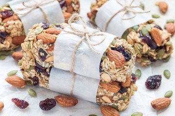 Fototapeta na wymiar Homemade granola energy bars with figs, oatmeal, almond, dry cranberry and pumpkin seeds, healthy snack