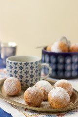 Vanilla krapfen doghnut with coffee. Rustic style.