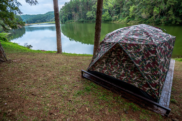 Tent for camping on grass in a hill near river, Traveling in Thailand