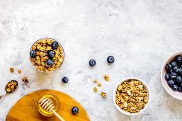 Oat flakes and berries granola glass on table background top vie