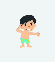Asian boy in a swimsuit, is angry and points his head with his index finger.