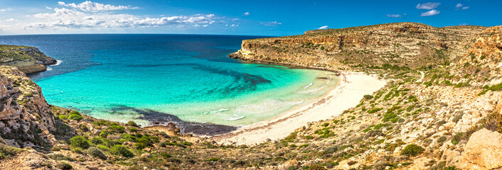 The Rabbit beach in Lampedusa, Pelagie islands is a wild beach, protected by WWF , for being home of the extinct loggerhead turtles, who lay theirs eggs in the area,  - obrazy, fototapety, plakaty