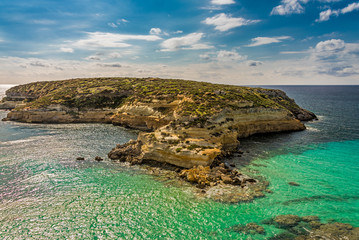 The Rabbit beach in Lampedusa, Pelagie islands is a wild beach, protected by WWF , for being home of the extinct loggerhead turtles, who lay theirs eggs in the area,  - obrazy, fototapety, plakaty