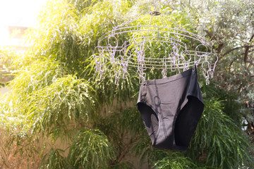 Black underwear is hanging on the clothes rack