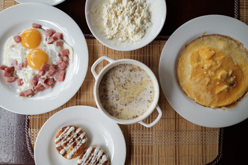 Breakfast. Scrambled eggs, cottage cheese, cheese cakes, omelet
