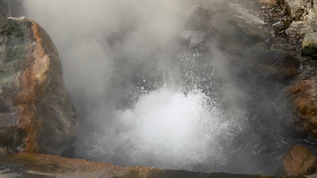 Natural hot spring. Slow motion shot of boiling water and evaporation. 4K, UHD