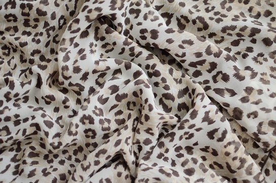 Chiffon fabric with leopard print. Closed Background