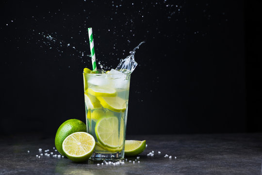 fresh summer caipirinha cocktail with splash