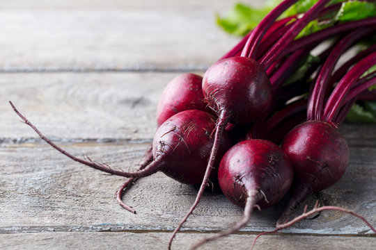 Fresh organic beet, beetroot on grey rustic wooden background. Copy space.
