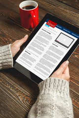 Woman reading news on tablet with cup of coffee. Online education concept. e-Learning