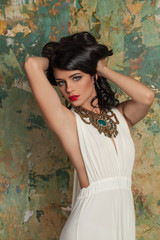 Beautiful Girl Fashion Model with Red Lips Makeup and Permed Hair. Brunette Model in White Dress