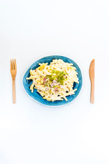 Italian food macaroni gratin with ham on table