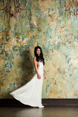 Beautiful Brunette Female Model in Trendy White Dress