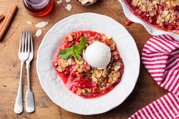 Crumble with berries and fruits with vanilla ice cream. Top view