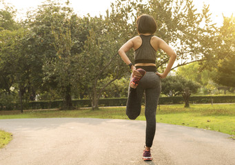 female exercising stretch her leg relax to muscle for running.