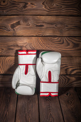 Boxing gloves on dark brown cracked wooden background