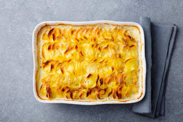Potato gratin, backed potato slices with creamy sauce. Top view.
