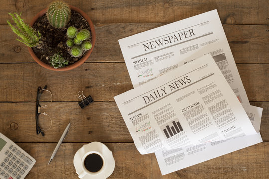 newspaper over wooden table
