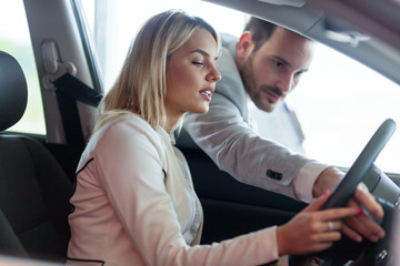 Portrait of happy customer buying new car