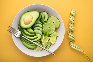 Fototapeta na wymiar Diet concept food on a pastel yellow background