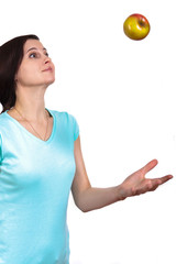 The girl in a t-shirt throws apple up