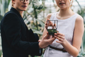 cropped shot of stylish young couple holding jewelry box with engagement ring